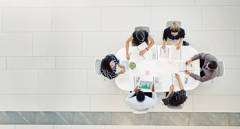 A group of people sitting around a table in an office