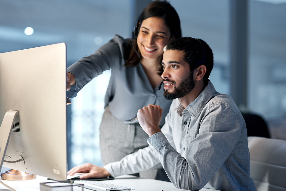 Two people looking at a computer screen together
